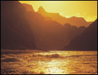 daily Devotion picture of golden sunset on the water with mountain peaks in the background