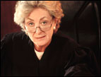 middle age femal judge in court robe in court setting