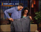 Pete Thomas demonstrates his former pants size to Kristi Watts