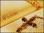 daily Devotion picture of open Bible with a necklace cross laying on top of the scriptures