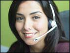 woman with brown hair and brown eyes with a telephone headset on her head