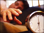 daily Devotion finding god's timing - sleeping person hand reaching for alarm clock