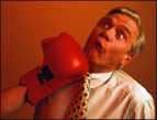 daily Devotion red boxing glove punching middle-aged man in jaw