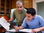 daily Devotion picture of middle aged man and teenage boy going over financial papers