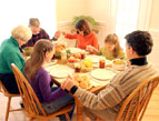 daily Devotion family praying holding hands at dinner table