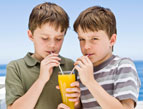 daily Devotion two boys sipping juice through straws sharing one glass