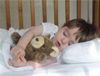 toddler sleeping with stuffed bear