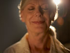 mature woman with light shining bright behind her head