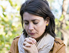 daily Devotion picture of young woman with brown hair praying