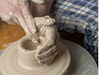 potter making a clay vessel