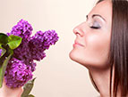 a woman smelling lavender flowers