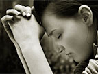 woman praying sincere prayer - black and white photo