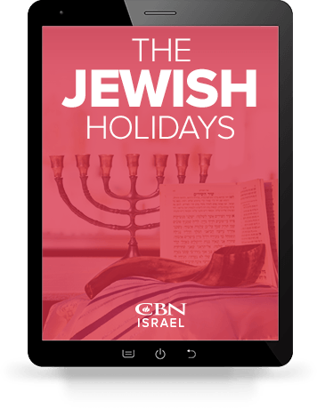 An iPad with an image of the downloadable Jewish Holidays Guide displaying.