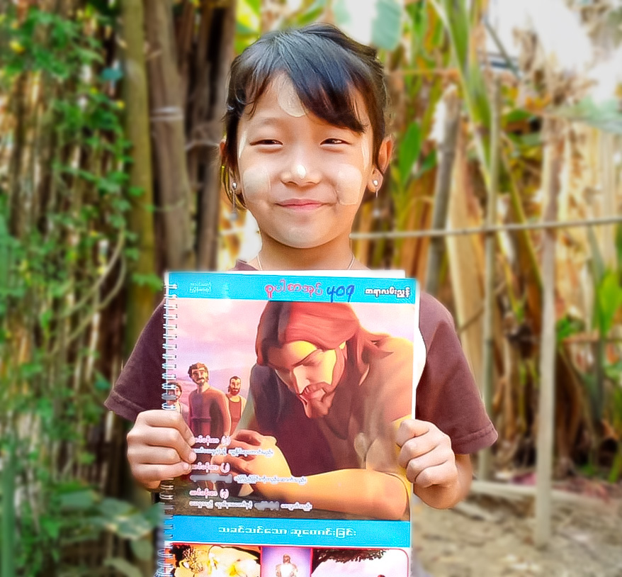Child holding a Superbook Booklet